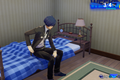 The protagonist sits on their bed in Persona 3 Reload