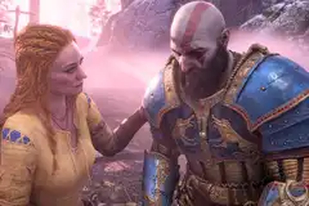 An image from God of War (2018) showing Faye, a red-haired woman with a yellow and blue tunic on, putting a hand on her husband, Kratos' plated shoulder.