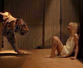 A tiger creeps up to a screaming blonde in Hot Spot