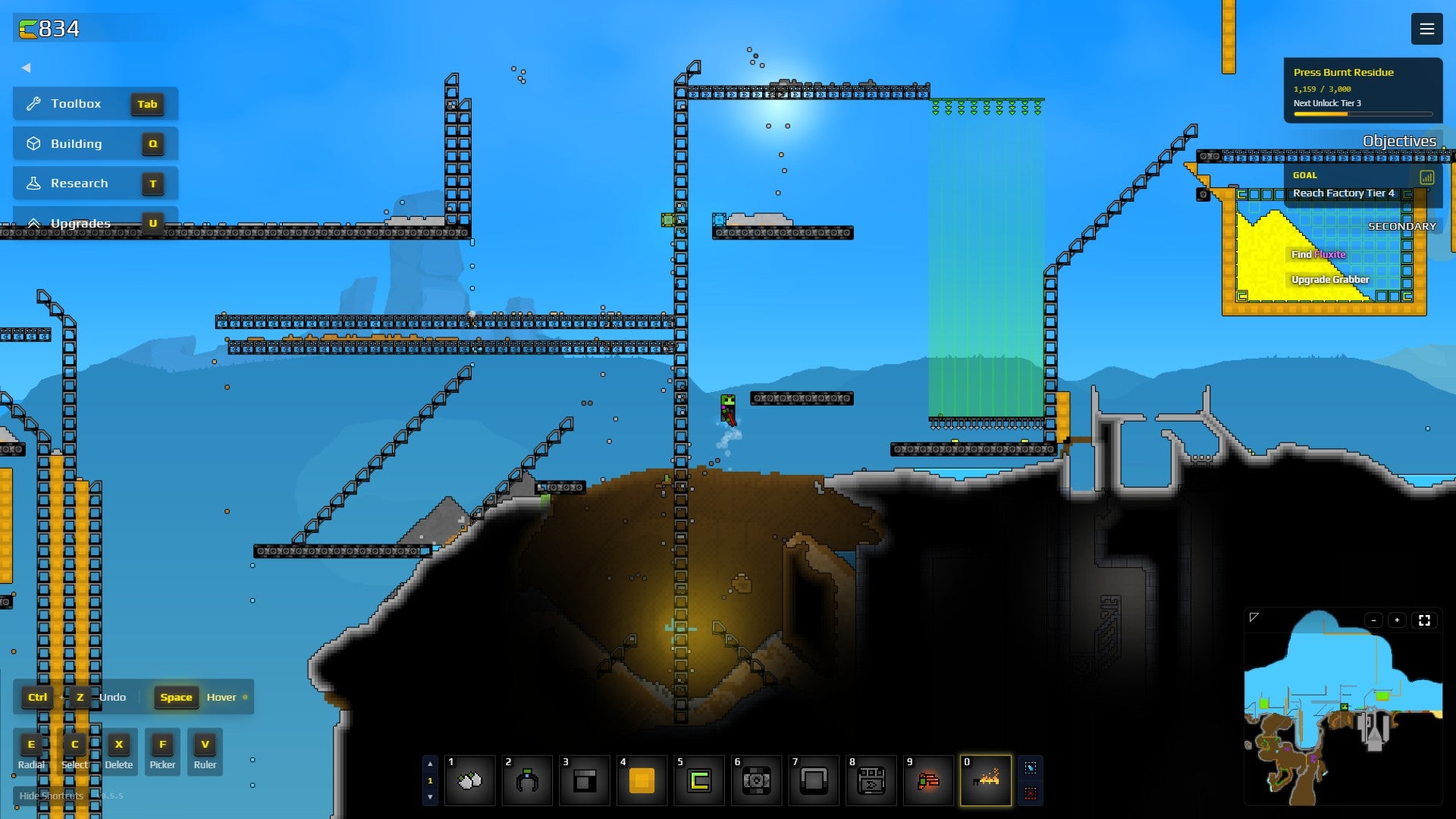 A rudimentary factory in Sandustry, with 2D conveyor belts and crates against a blue alien sky.