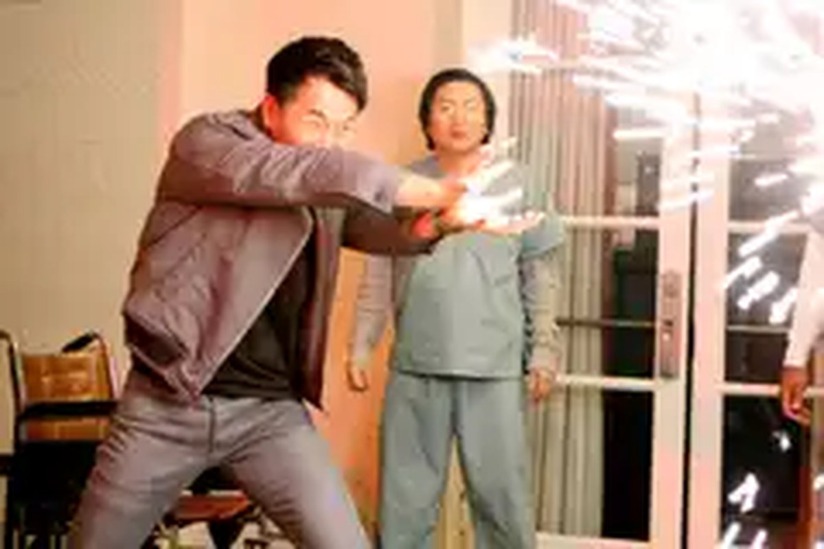 James Kyson Lee blasts a wall with an explosion of sparks as Masi Oka stands by in Heroes