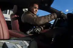 Raul Bautista holds a gun in the drivers seat of his car in Grand Theft Auto 6