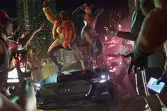 Two people dancing on a car hood in Grand Theft Auto 6.