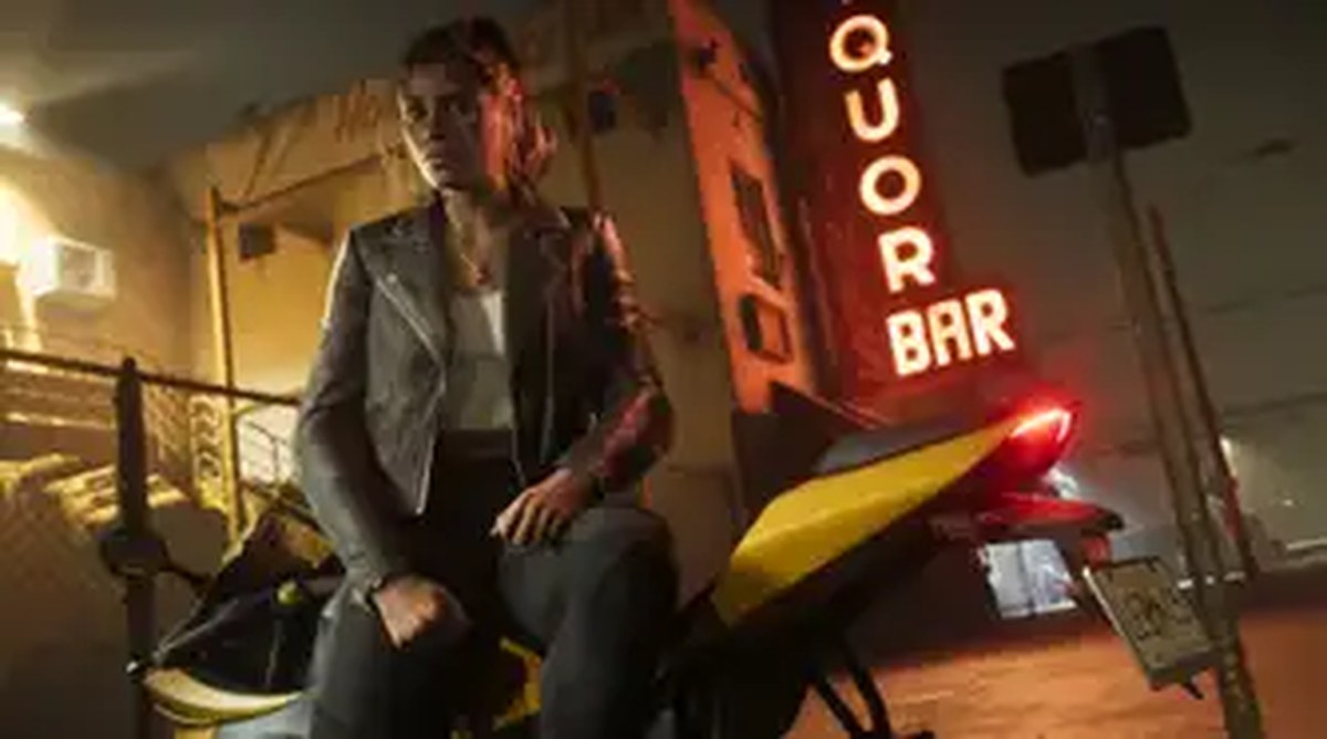 Lucia Caminos sites on a motorcycle outside of a bar in a still from Grand Theft Auto 6