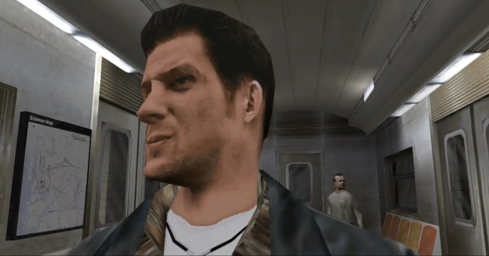 A closeup of Max Payne as he stands inside the subway with a passenger behind him