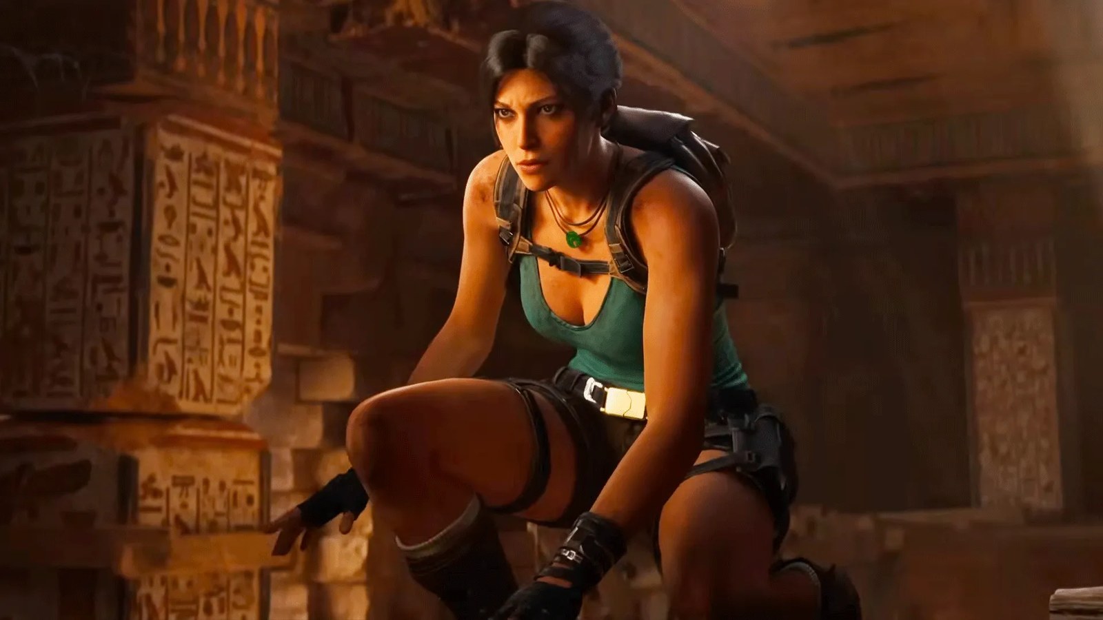 Lara Croft kneeling in a tomb.
