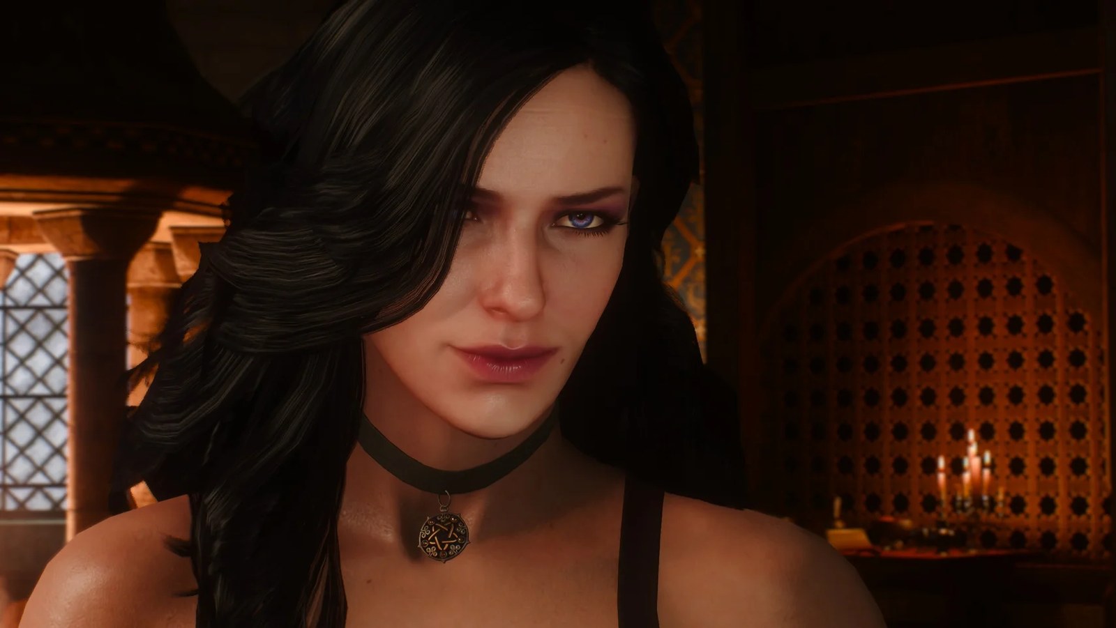 A pretty woman with raven-black hair looks towards the camera.
